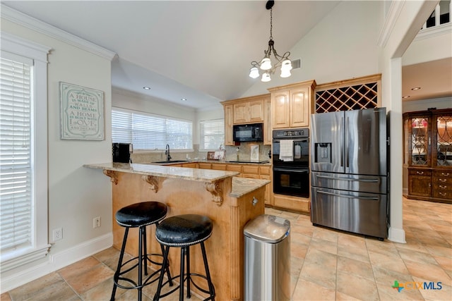 kitchen with backsplash, black appliances, sink, vaulted ceiling, and light stone counters