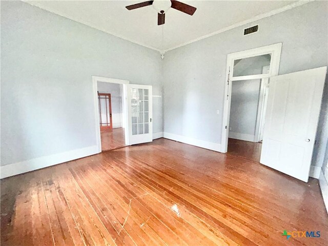 502 E Live Oak St, Cuero, TX 77954 - unfurnished bedroom featuring hardwood / wood-style flooring, a closet, ceiling fan, and french doors