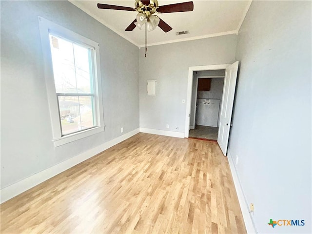 502 E Live Oak St, Cuero, TX 77954 - unfurnished bedroom featuring ceiling fan, light hardwood / wood-style flooring, crown molding, and multiple windows