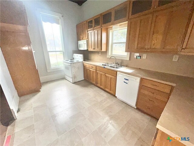 502 E Live Oak St, Cuero, TX 77954 - kitchen featuring sink, white appliances, and a healthy amount of sunlight