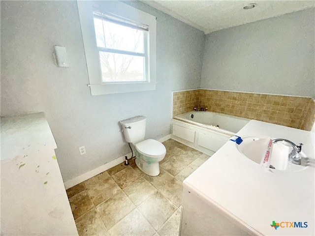 502 E Live Oak St, Cuero, TX 77954 - bathroom with sink, a bathtub, and toilet