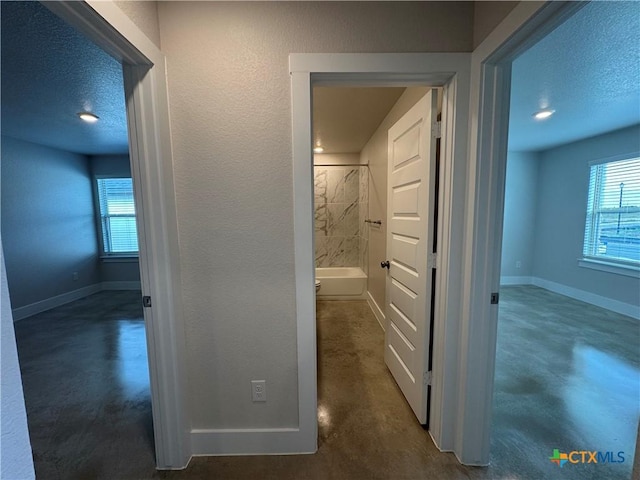 hallway featuring a textured ceiling