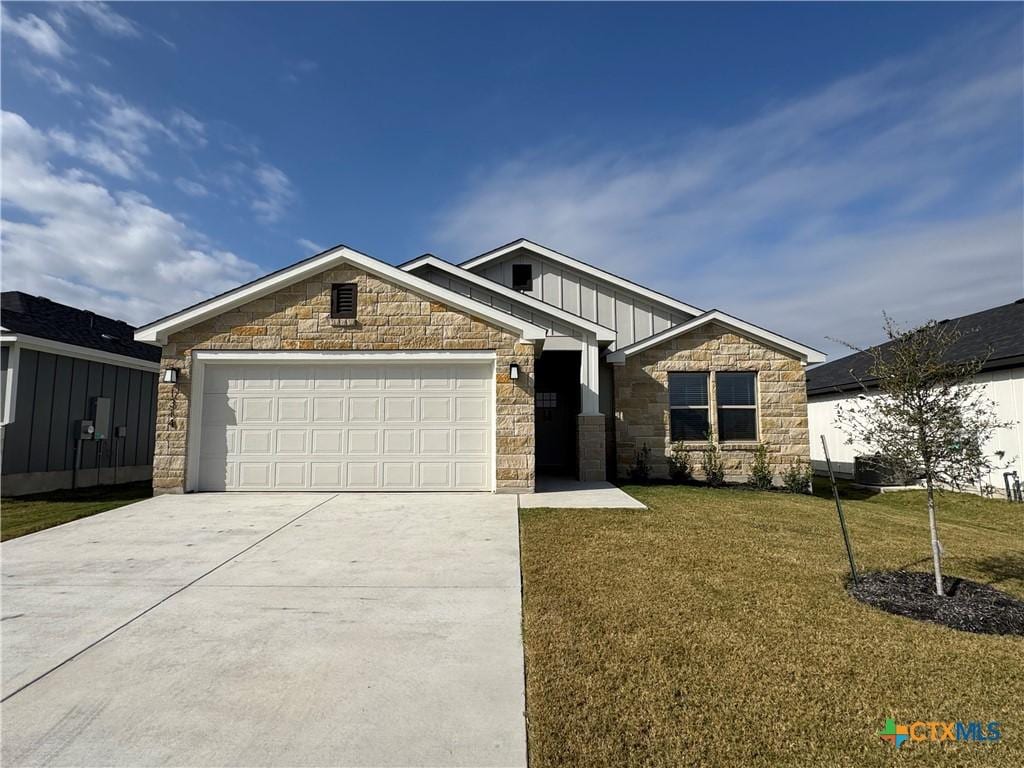 craftsman-style home with a front yard and a garage