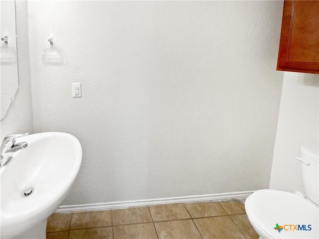 bathroom featuring tile patterned floors, sink, and toilet