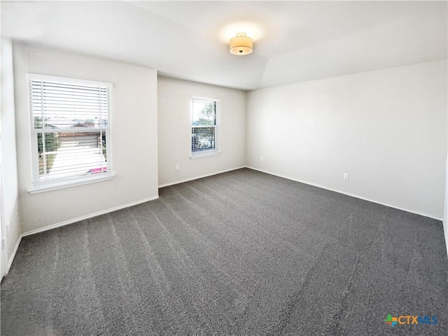 unfurnished room with dark carpet