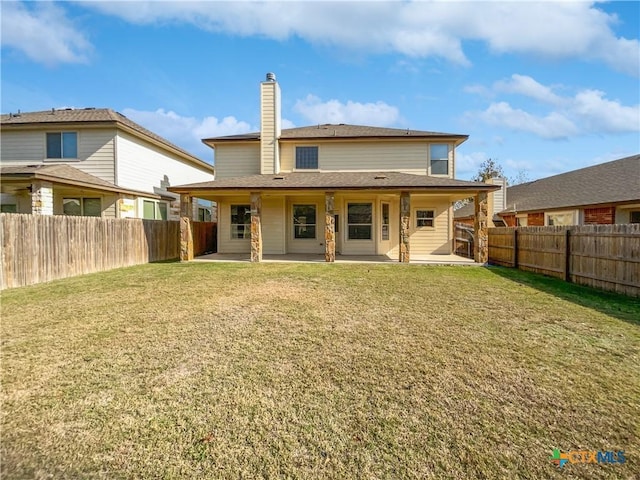 rear view of property featuring a lawn and a patio