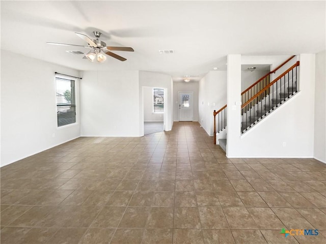 unfurnished living room featuring ceiling fan and tile patterned flooring