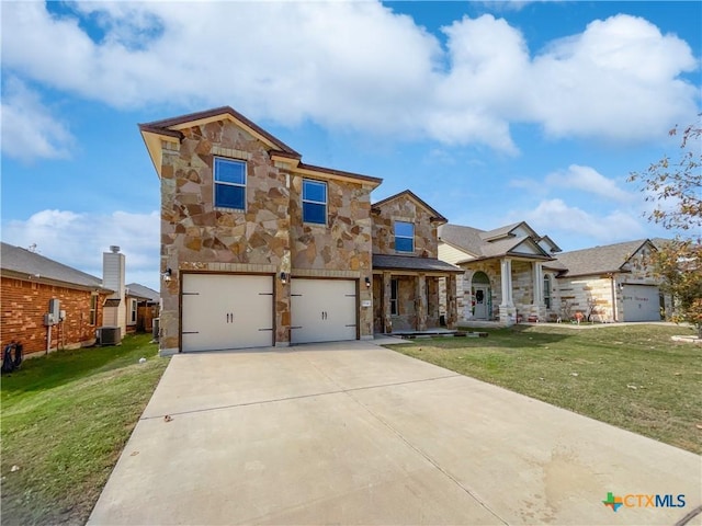 view of front of home with a garage, central air condition unit, and a front lawn