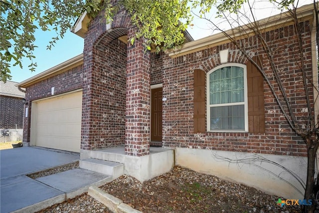 view of exterior entry featuring a garage