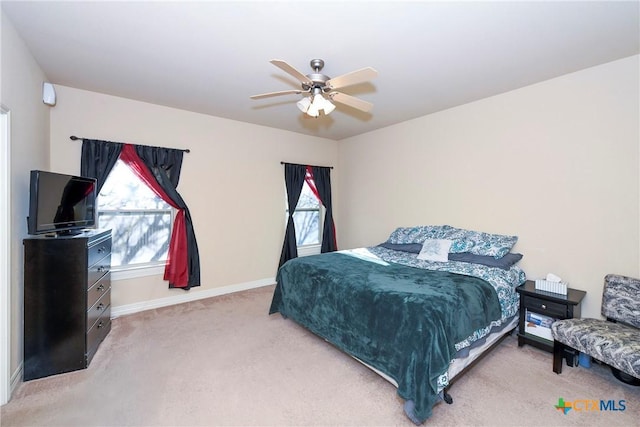 carpeted bedroom with multiple windows and ceiling fan