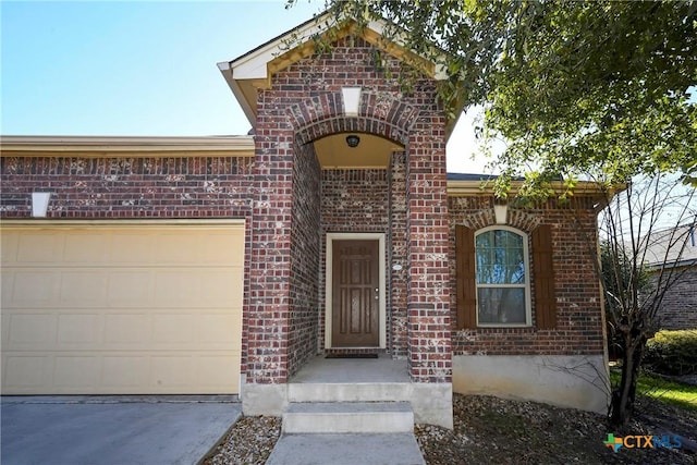 doorway to property with a garage