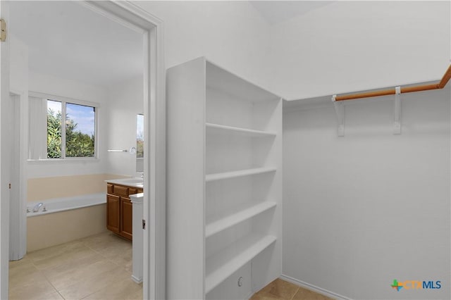 spacious closet featuring light tile patterned floors