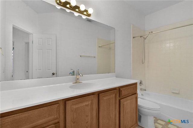 full bathroom with vanity, tiled shower / bath combo, and toilet