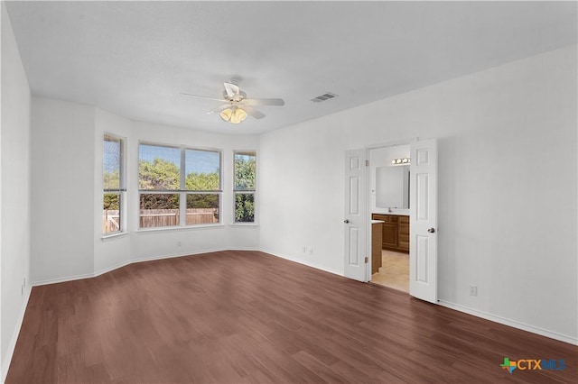 spare room with ceiling fan and wood-type flooring