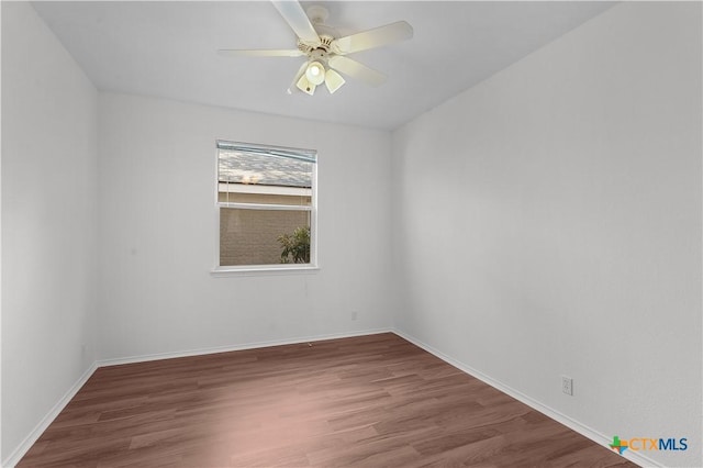 empty room with hardwood / wood-style floors and ceiling fan