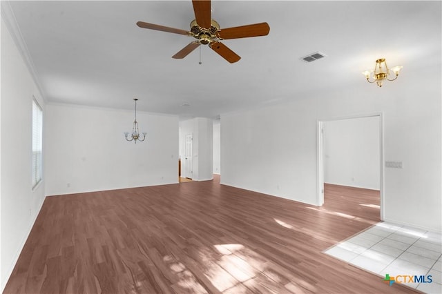 unfurnished living room with crown molding, light hardwood / wood-style floors, and ceiling fan with notable chandelier