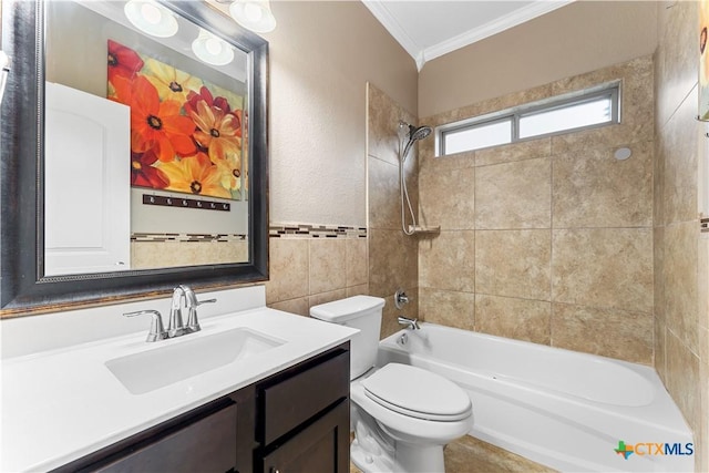bathroom featuring crown molding, washtub / shower combination, vanity, toilet, and tile walls