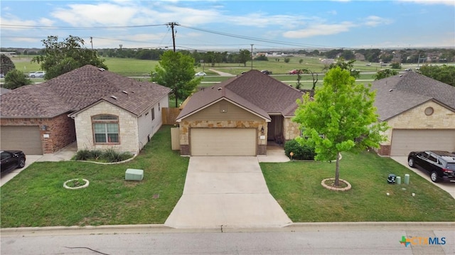 view of front of home featuring a garage, a front yard, driveway, and stone siding