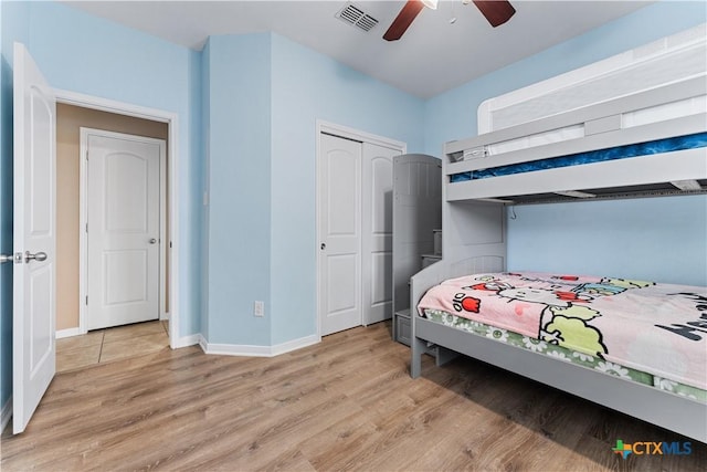 bedroom with baseboards, a closet, light wood-type flooring, and visible vents