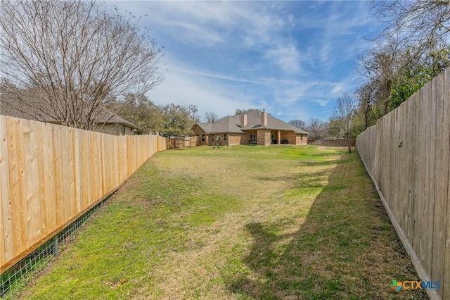 view of yard with a fenced backyard