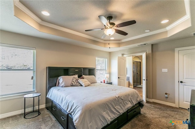 bedroom featuring visible vents, crown molding, baseboards, carpet floors, and a raised ceiling