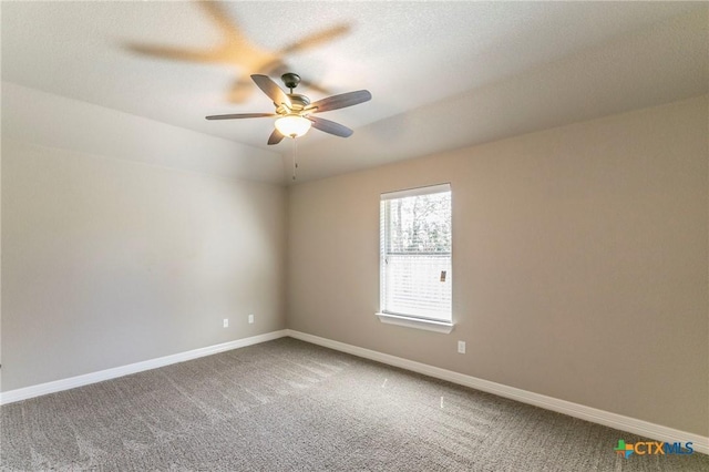 carpeted empty room featuring a ceiling fan, baseboards, and a textured ceiling