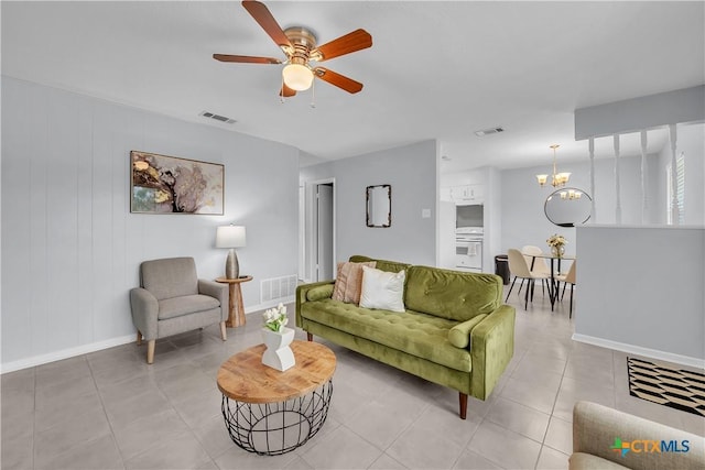 2918 Antelope Trl, Temple, TX 76504 - tiled living room featuring ceiling fan with notable chandelier