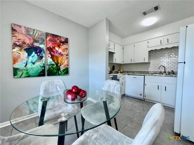 2918 Antelope Trl, Temple, TX 76504 - kitchen featuring light tile patterned flooring, tasteful backsplash, sink, white cabinets, and white appliances