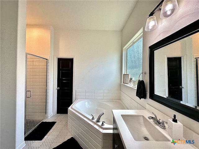 bathroom with tile patterned flooring, sink, and plus walk in shower