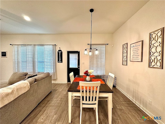 dining area featuring hardwood / wood-style flooring and a notable chandelier