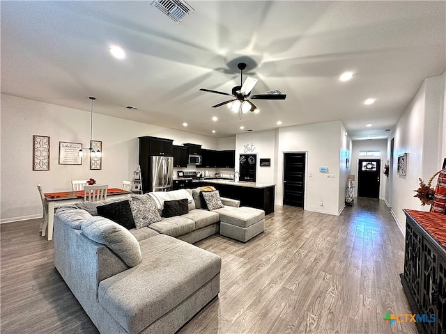 living room with hardwood / wood-style floors and ceiling fan