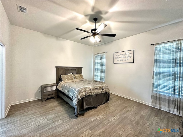 bedroom with hardwood / wood-style flooring and ceiling fan