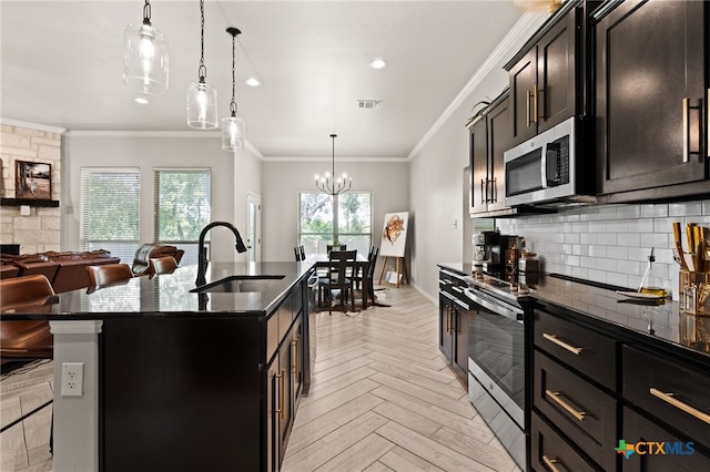 2823 Pistoia Trl, Temple, TX 76502 - kitchen with stainless steel appliances, open floor plan, decorative backsplash, an island with sink, and crown molding