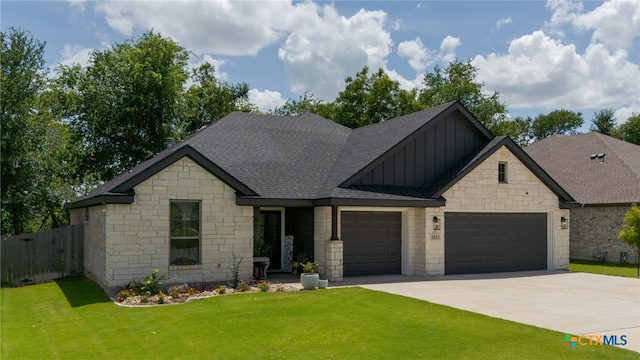 2823 Pistoia Trl, Temple, TX 76502 - view of front of property featuring board and batten siding, a garage, stone siding, driveway, and roof with shingles