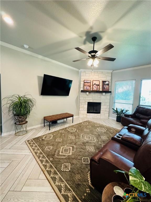 2823 Pistoia Trl, Temple, TX 76502 - living area with a ceiling fan, ornamental molding, and a large fireplace