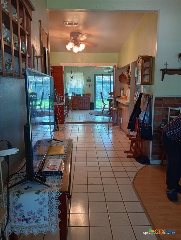 hall with visible vents and light tile patterned floors