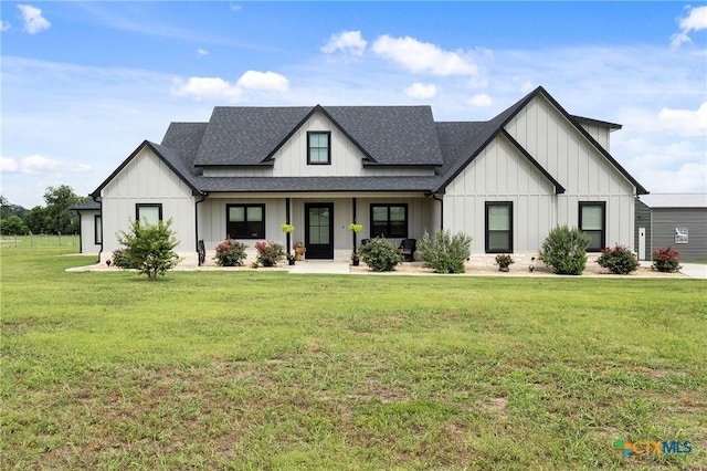 modern inspired farmhouse featuring roof with shingles, board and batten siding, and a front lawn