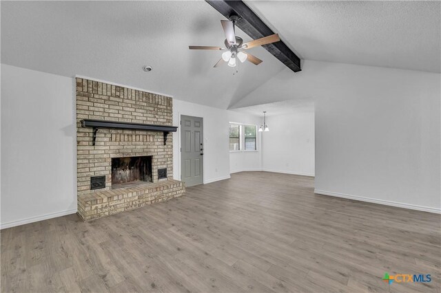 2316 Schwertner Dr, Killeen, TX 76543 - unfurnished living room with wood finished floors, a fireplace, a ceiling fan, a chandelier, and a textured ceiling