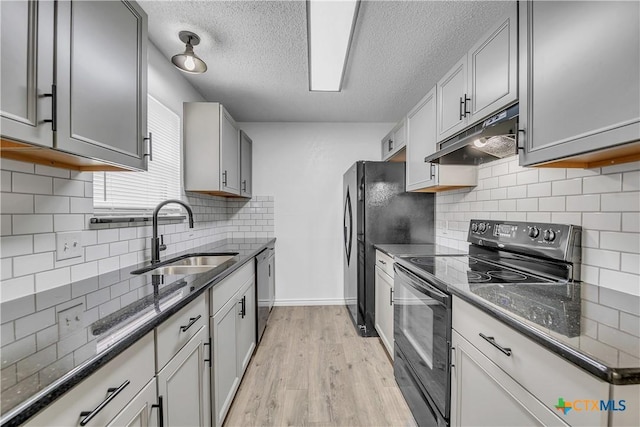 2316 Schwertner Dr, Killeen, TX 76543 - kitchen featuring black / electric stove, under cabinet range hood, a textured ceiling, light wood-style flooring, and decorative backsplash