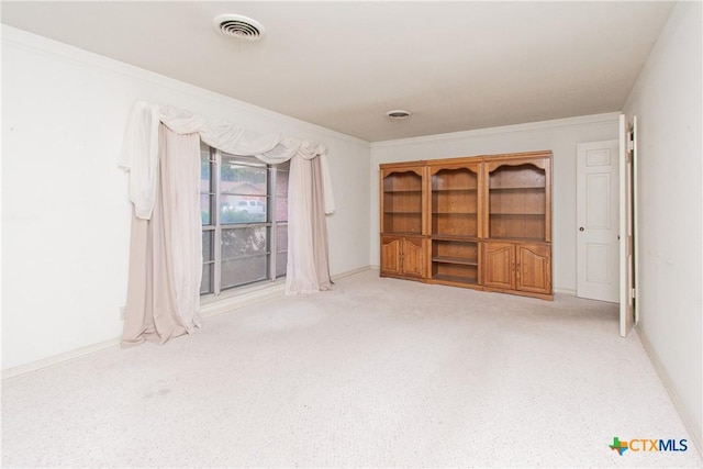 unfurnished bedroom featuring crown molding and light carpet