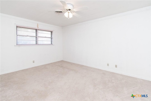 carpeted spare room with ornamental molding and ceiling fan