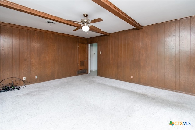 carpeted spare room featuring beam ceiling and ceiling fan