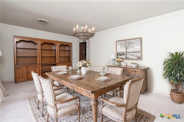 carpeted dining space featuring ornamental molding and a notable chandelier