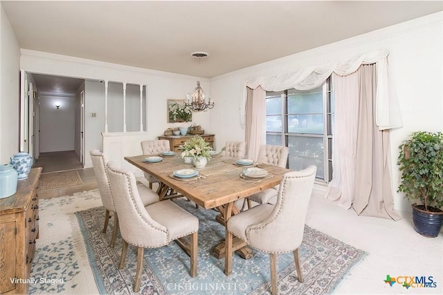 dining room with an inviting chandelier and crown molding