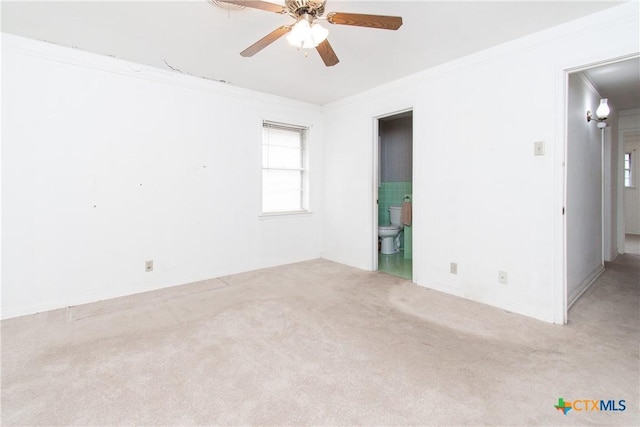 carpeted spare room with ornamental molding and ceiling fan