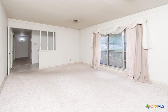 spare room featuring crown molding