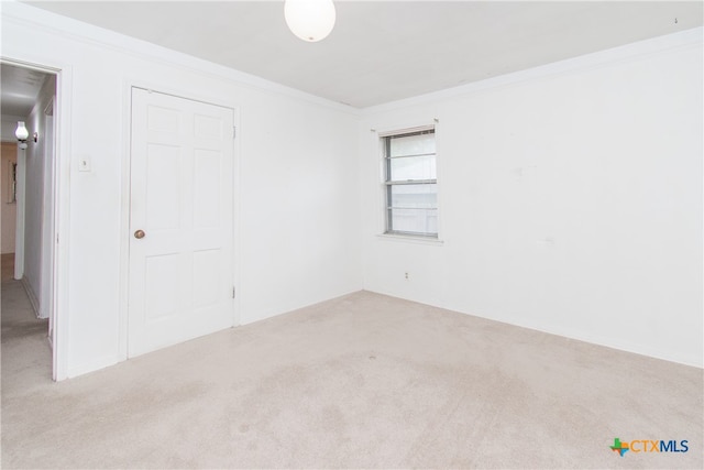 carpeted spare room with ornamental molding