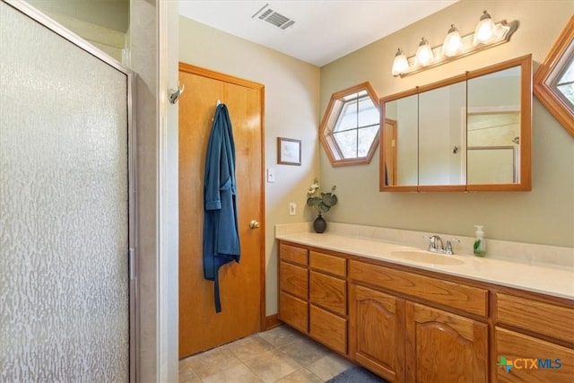 15938 Goliad Loop, Temple, TX 76502 - full bath featuring vanity, a shower stall, healthy amount of natural light, and tile patterned flooring