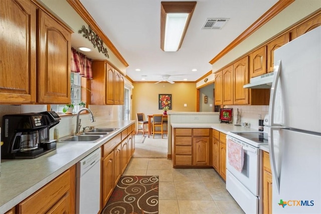 15938 Goliad Loop, Temple, TX 76502 - kitchen featuring white appliances, under cabinet range hood, decorative backsplash, crown molding, and a peninsula