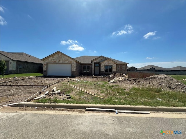 403 Magnolia Dr, Troy, TX 76579 - ranch-style home featuring a garage, stone siding, and driveway